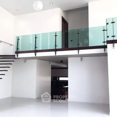 Modern minimalist interior with glass balcony and open layout