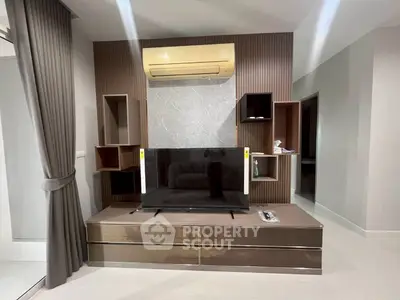 Modern living room with sleek TV unit and air conditioning, featuring stylish shelving and elegant curtains.