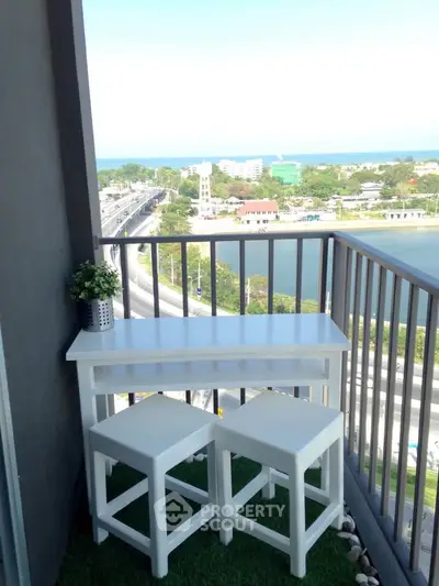 Charming balcony with seating and stunning city and sea view, perfect for relaxation and enjoying the outdoors.