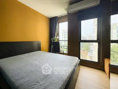 Modern bedroom with large windows and stylish decor in urban apartment