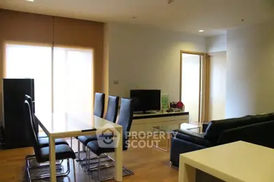 Modern living room with dining area and sleek furniture in a cozy apartment.