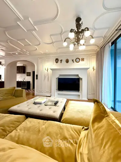 Luxurious living room with elegant chandelier and plush seating in a sophisticated interior design.