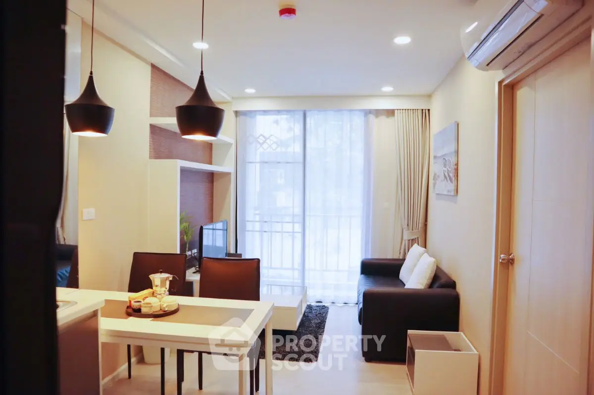 Modern living room with stylish decor and open layout, featuring cozy seating and elegant lighting.