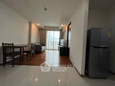 Modern living room with dining area and balcony view in a stylish apartment.