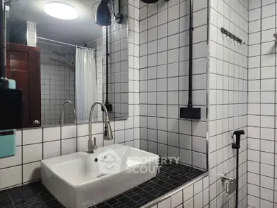 Modern bathroom with sleek white tiles and contemporary fixtures