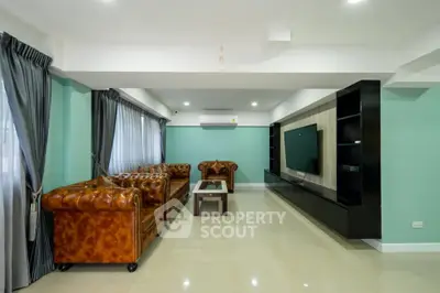 Spacious living room with elegant leather sofas and modern entertainment unit