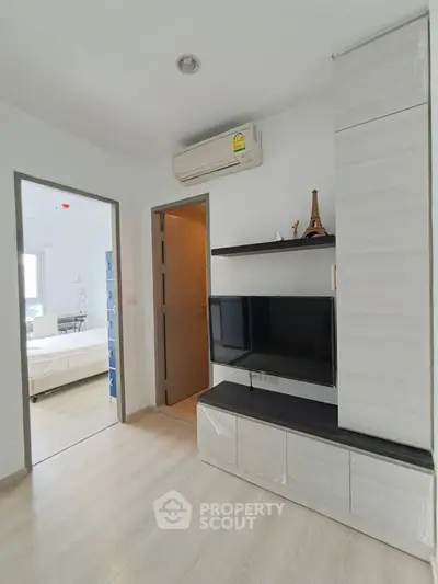 Modern living room with sleek TV unit and air conditioning