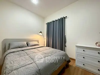 Cozy bedroom with modern decor and ample natural light
