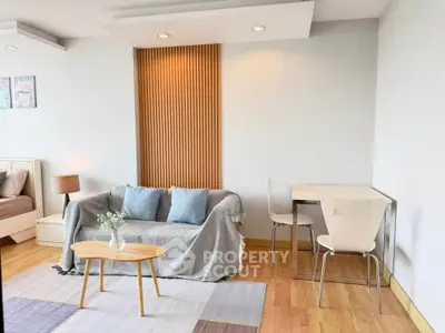 Modern living room with cozy sofa, stylish decor, and natural light