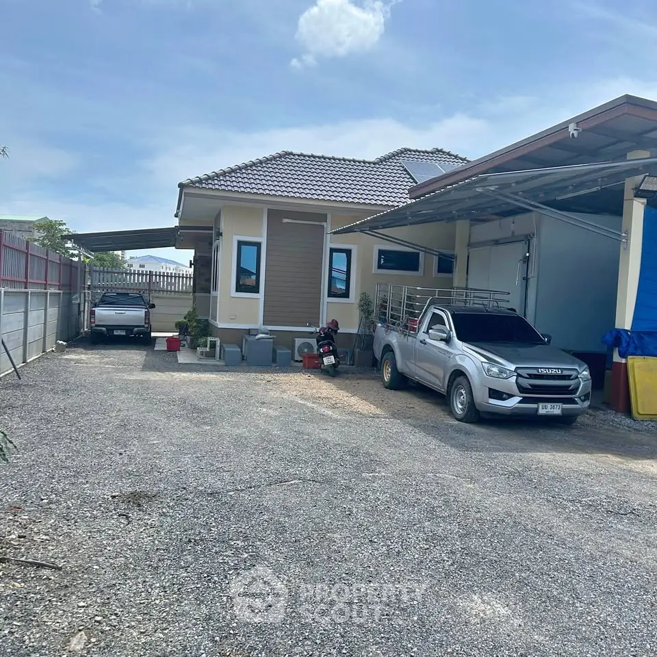 Charming single-story home with spacious driveway and modern exterior design, perfect for family living.
