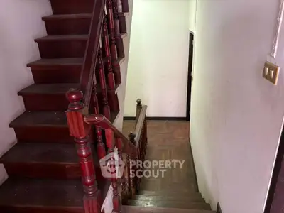 Charming wooden staircase with elegant railing in a cozy home interior
