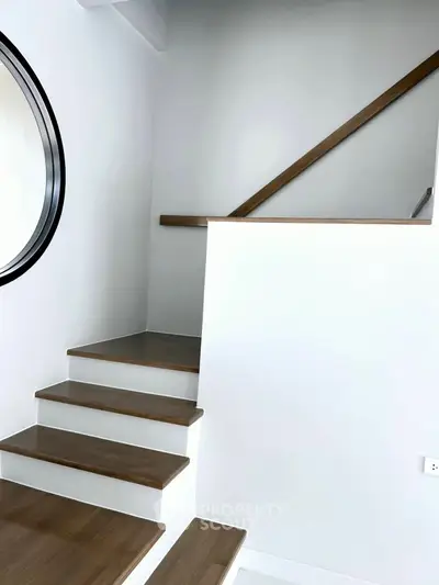 Modern staircase with wooden steps and sleek design in a contemporary home