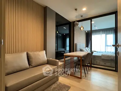 Modern living room with stylish decor and dining area in open layout apartment.