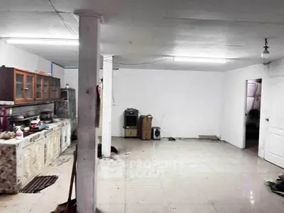 Spacious open-plan kitchen with ample storage and tiled flooring