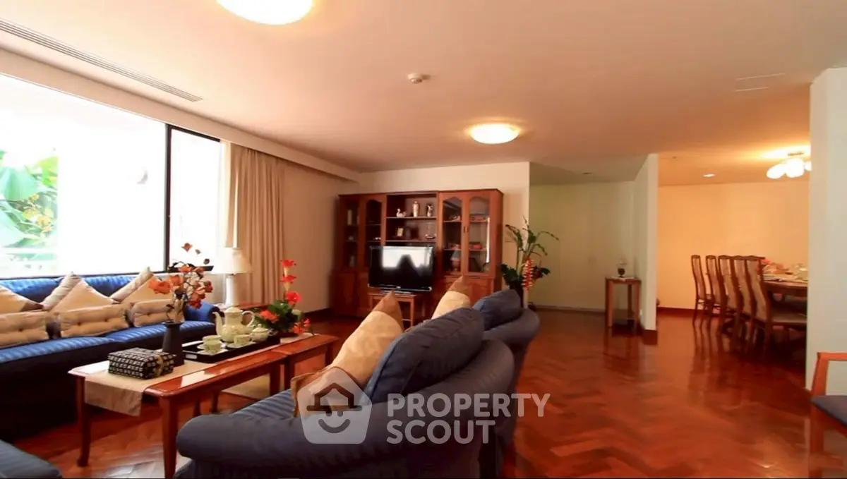 Spacious living room with elegant decor and large windows for natural light.