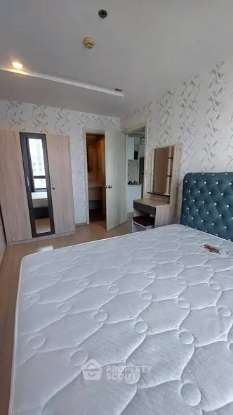 Spacious bedroom with modern decor and large wardrobe