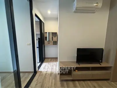 Modern apartment interior with sleek TV stand and air conditioning
