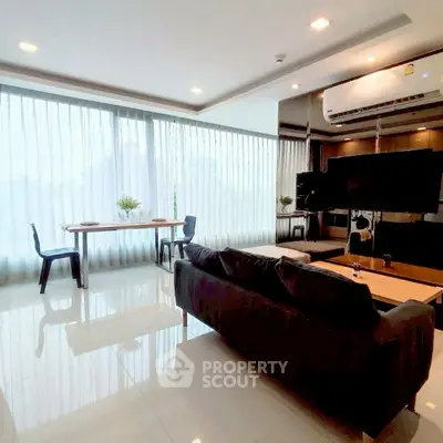 Spacious modern living room with large windows and sleek furniture