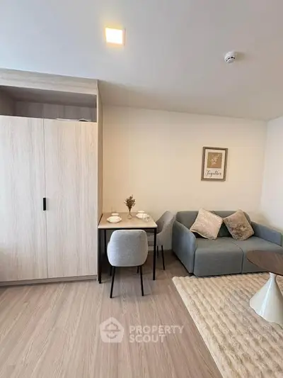 Modern living room with cozy sofa and dining area in stylish apartment.