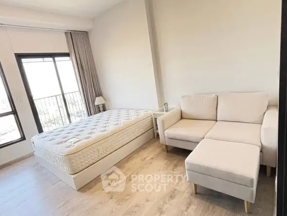 Modern bedroom with cozy sofa and large window view