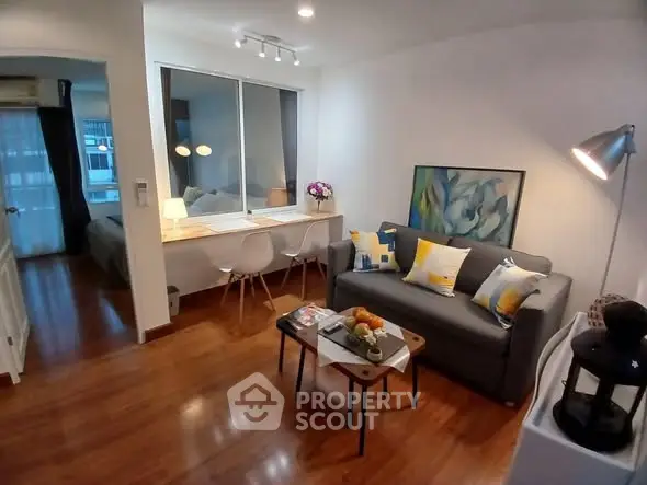 Charming living room with modern decor and cozy seating in a stylish apartment.