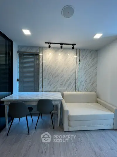 Modern living room with elegant marble wall and cozy seating area
