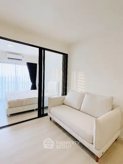 Modern apartment with glass partitioned bedroom and cozy living area