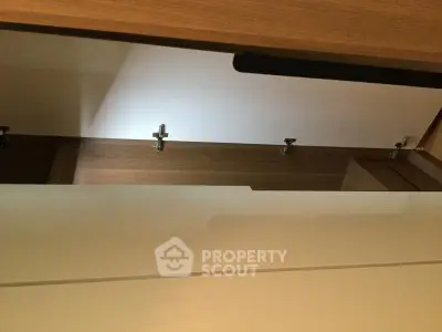 Modern interior storage space with sleek wooden finish and minimalist design.