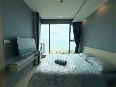 Luxurious bedroom with stunning ocean view and modern decor in high-rise apartment.