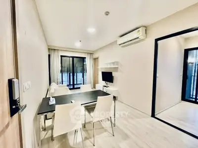 Modern living room with dining area and air conditioning in a stylish apartment.