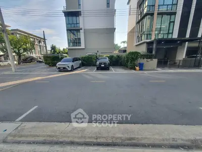 Modern residential building with parking area in urban setting