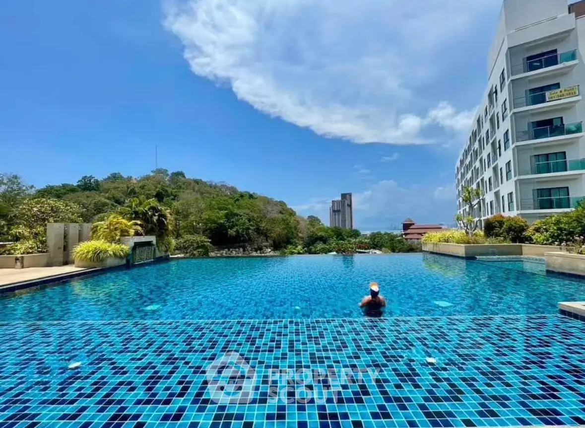 Luxurious apartment complex with stunning outdoor pool and scenic views.