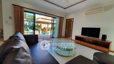 Spacious living room with pool view and modern furnishings