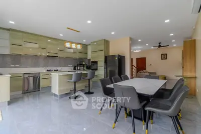 Spacious modern kitchen with dining area and sleek appliances