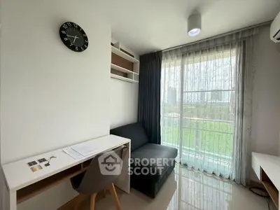 Modern study room with desk, chair, and sofa overlooking a scenic view through large windows.