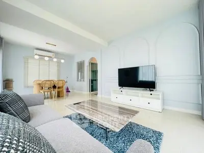 Spacious modern living room with stylish decor and large TV