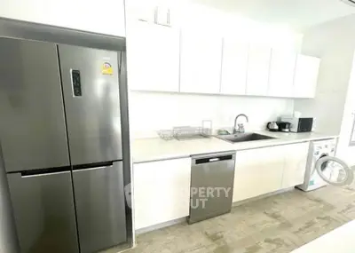 Modern kitchen with sleek appliances and ample storage space