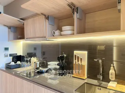 Modern kitchen with sleek cabinetry and high-end appliances, featuring an elegant open layout design.