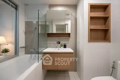 Modern bathroom with sleek fixtures and wooden accents