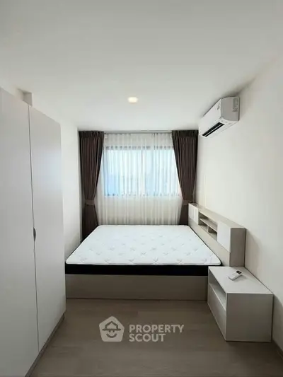 Modern minimalist bedroom with natural light and sleek furnishings