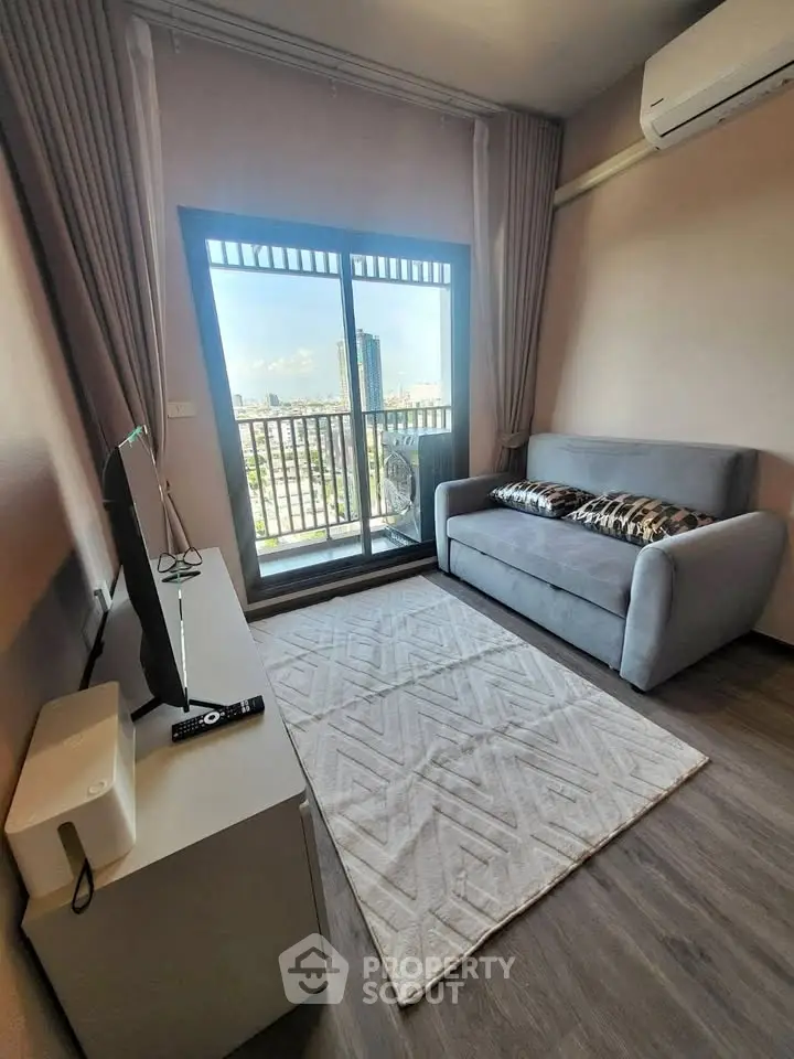 Modern living room with balcony view, featuring sleek furniture and air conditioning.