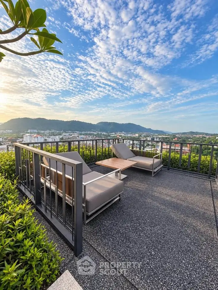 Stunning rooftop terrace with panoramic city and mountain views, featuring modern outdoor seating.