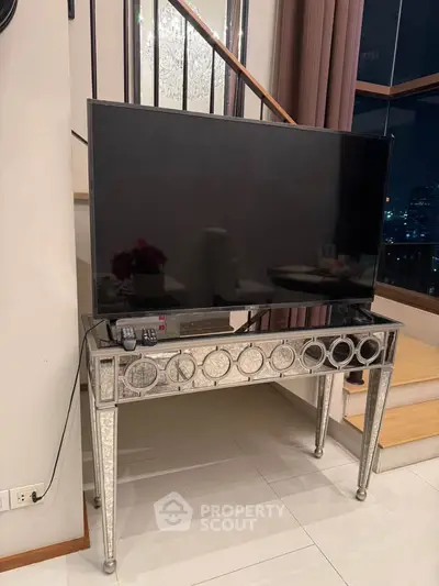 Elegant living room with stylish TV stand and large flat-screen TV