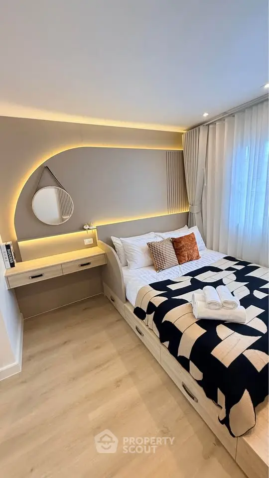 Modern bedroom with stylish lighting and cozy decor in a contemporary apartment.