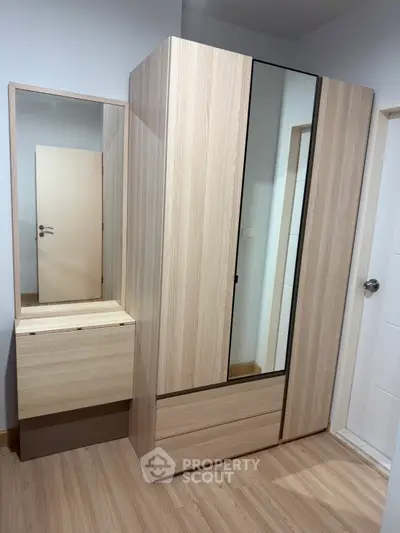Modern bedroom with sleek wooden wardrobe and mirror