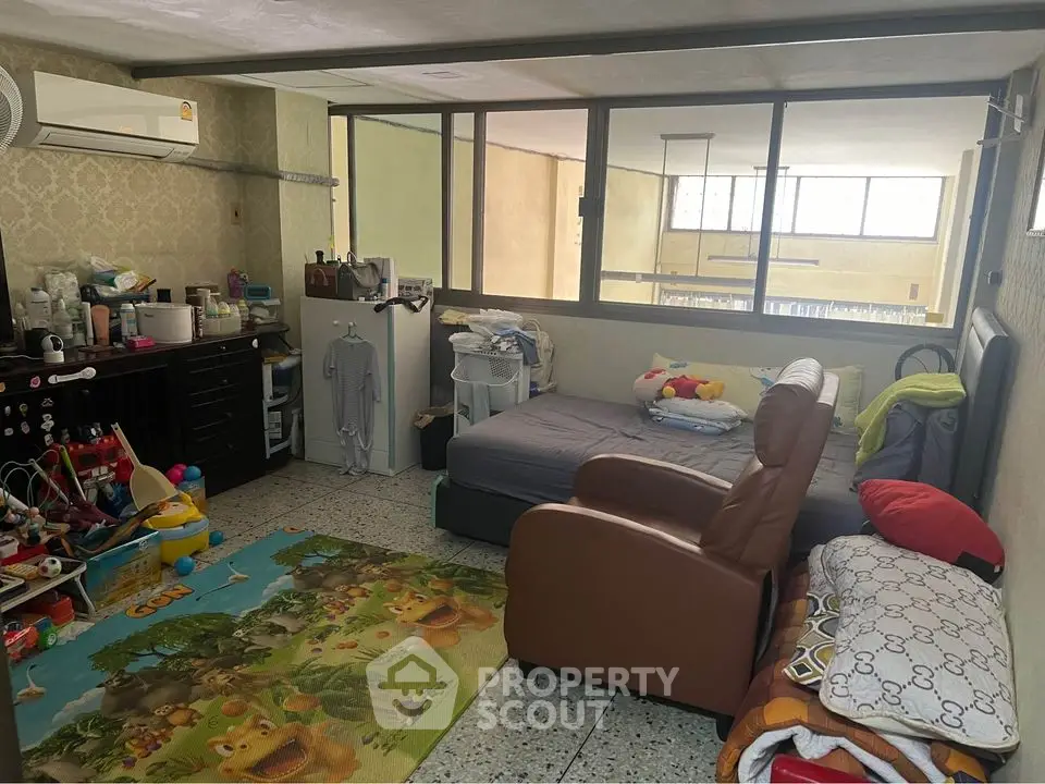 Spacious bedroom with playful decor and ample natural light