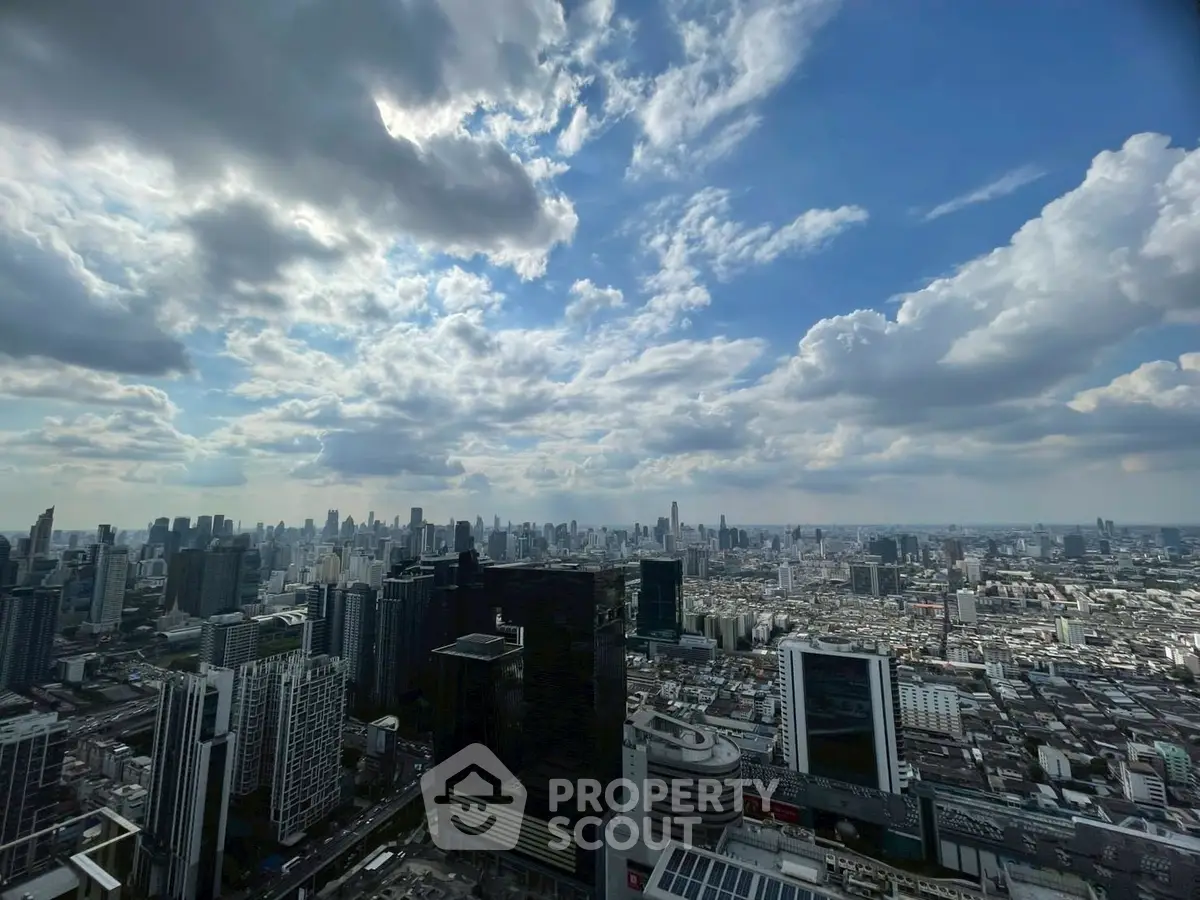 Stunning cityscape view from high-rise building showcasing urban skyline under a vibrant sky.
