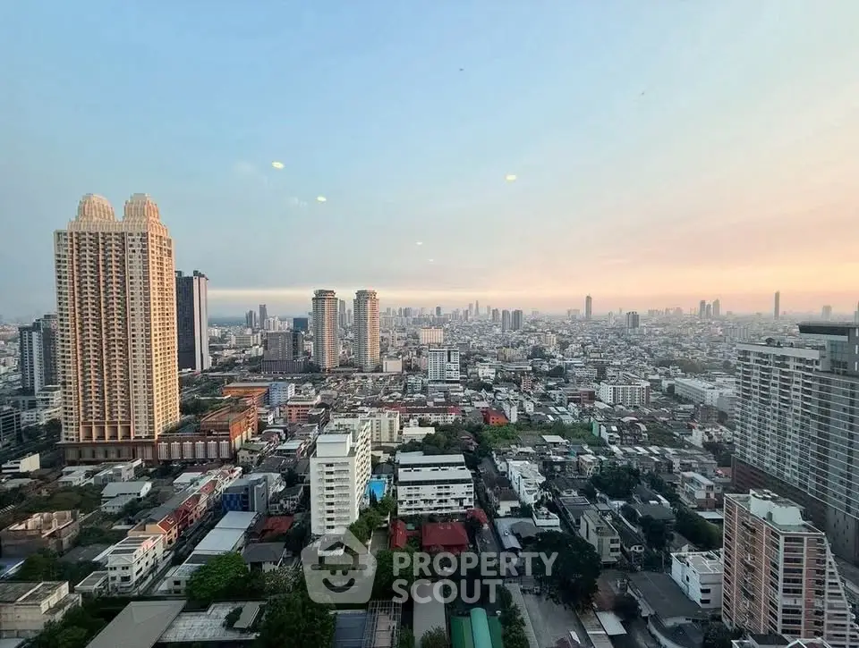 Stunning cityscape view from high-rise apartment showcasing urban skyline at sunset.