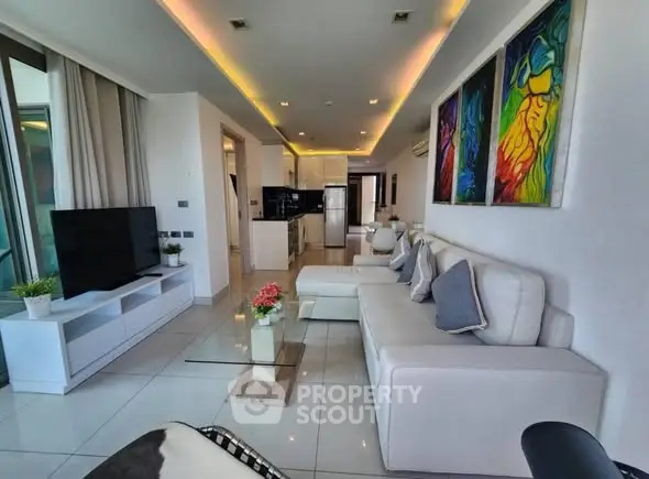 Luxurious modern living room with elegant white furniture and vibrant artwork, perfect for stylish urban living.
