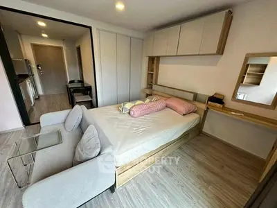 Modern studio apartment with cozy bed and stylish decor